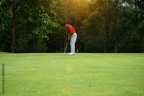 Blurred golfers are putting golf in the evening golf course golf backglound in Thailand photo