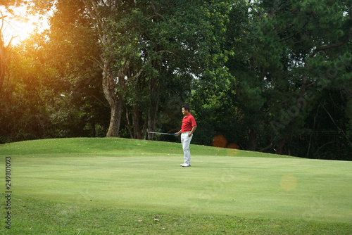 Blurred golfers are putting golf in the evening golf course golf backglound in Thailand