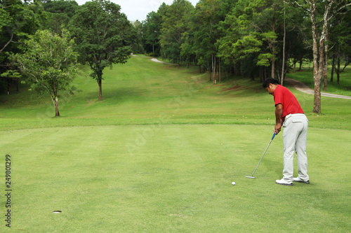 Golfers are putting golf in the evening golf course golf backglound in Thailand photo