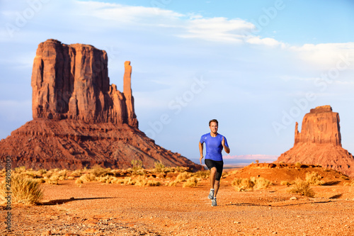 Trail running runner athlete doing race goal challenge. Fitness man sprinting across desert in Monument Valley, cross country marathon endurance training in Arizona, Utah, USA. American travel.