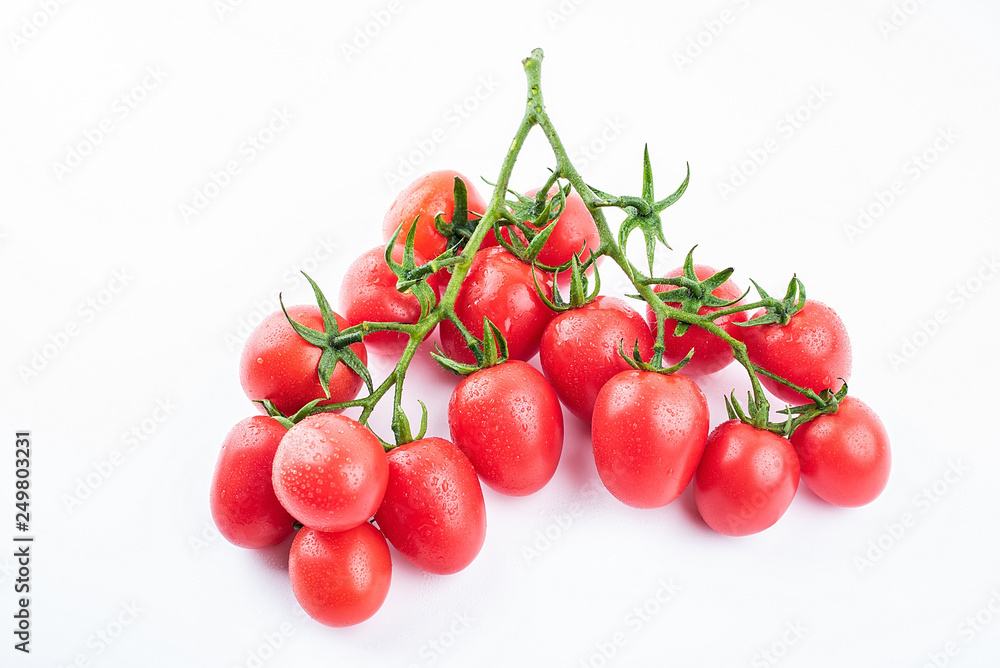a bunch of red small tomatoes on a white background