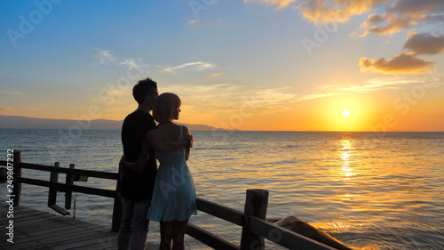 Beautiful Young Couple in Love Hug at Sunset time with Sea view