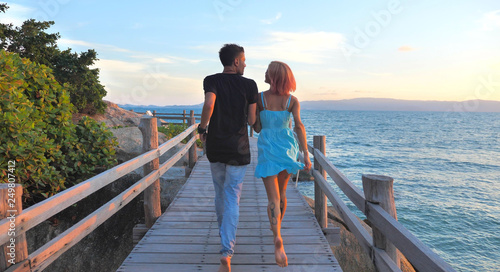 Beautiful Young Couple in Love spend time Together at Sunset time with Sea view © Glebstock