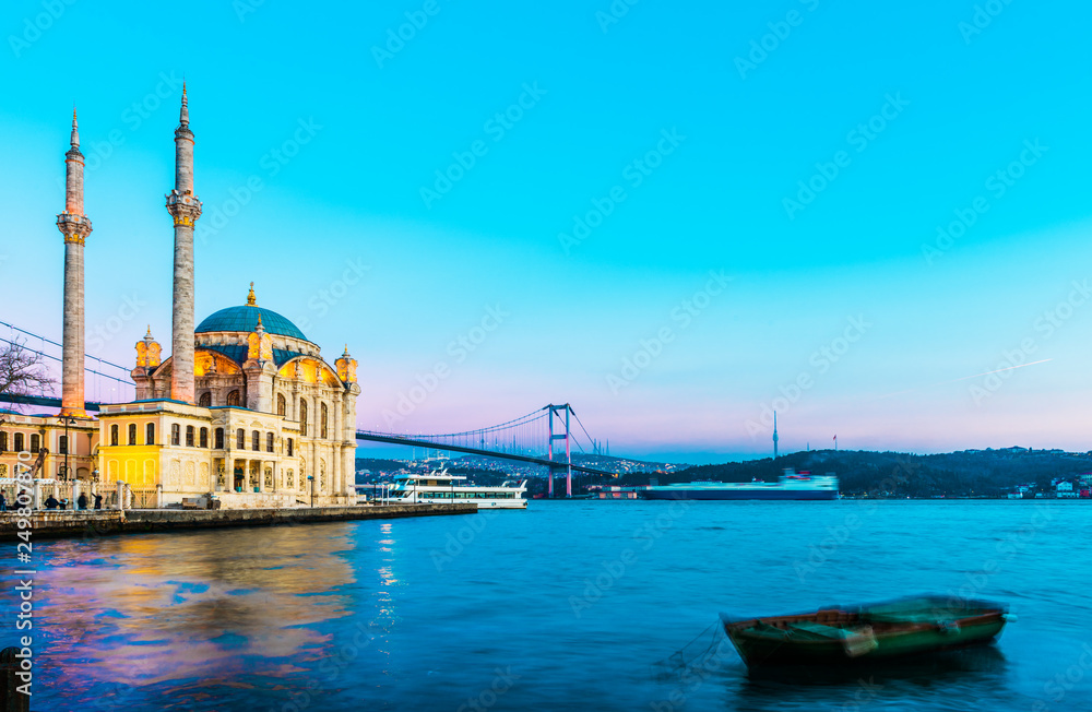 Ortakoy Mosque and Bosphorus Bridge (15th July Martyrs Bridge) sunset view. Istanbul, Turkey..