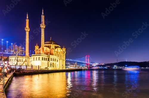 Ortakoy Mosque and Bosphorus Bridge (15th July Martyrs Bridge) night view. Istanbul, Turkey.. photo
