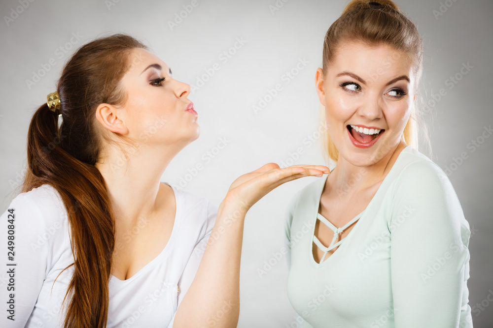Happy women sending air kisses Happy women sending air kisses