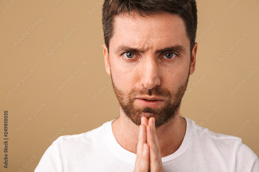 Portrait of a pensive young man standing isolated Portrait of a pensive young man standing isolated