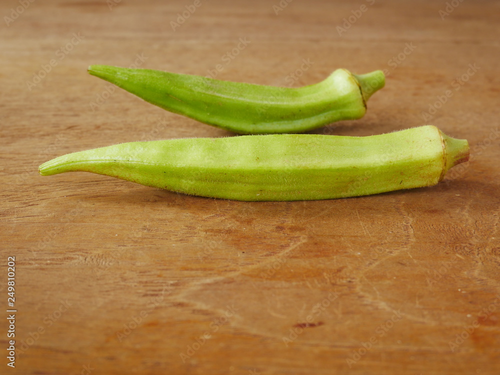 fresh okra on wood background,organic vegetable food fresh okra on wood background,organic vegetable food