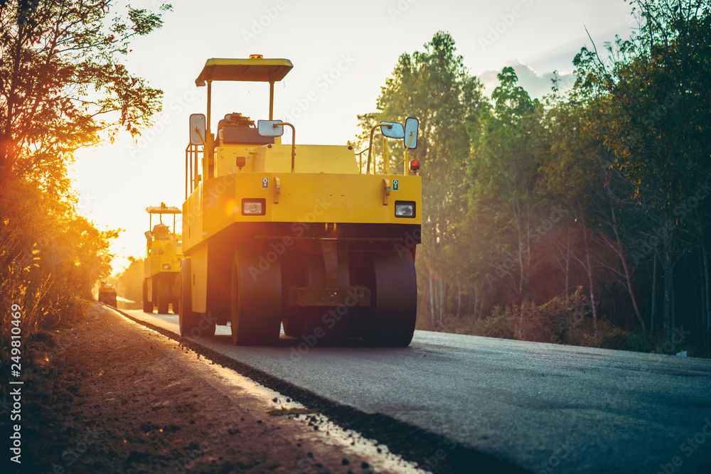 Road works in the city. Working on special equipment cut off the old asphalt on a Sunny summer day Road works in the city. Working on special equipment cut off the old asphalt on a Sunny summer day