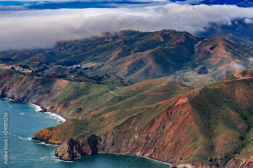Photography Rugged cliffs above Pacific Ocean by Point Bonita Lighthouse and fog rolling in