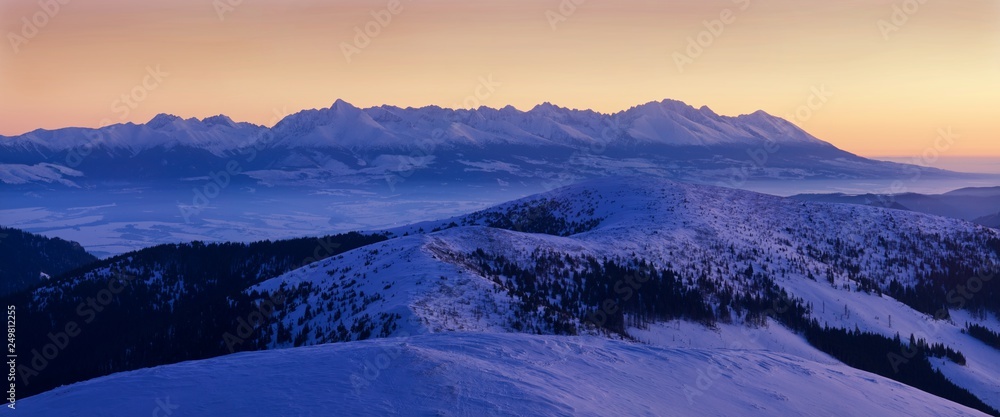 Mountain landscape panoramic view with blue sky Gorgeous winter sunset in Carpathian mountains. Colorful outdoor scene, Happy New Year celebration concept. Panorama of white winter mountains with snow