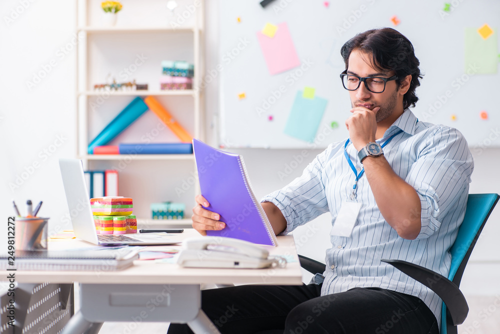 Young handsome male designer working in the office Young handsome male designer working in the office