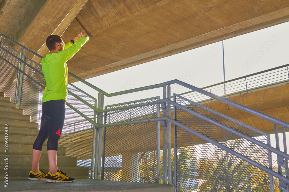 Sportsman working out / jogging on a big city urban bridge. Sportsman working out / jogging on a big city urban bridge.