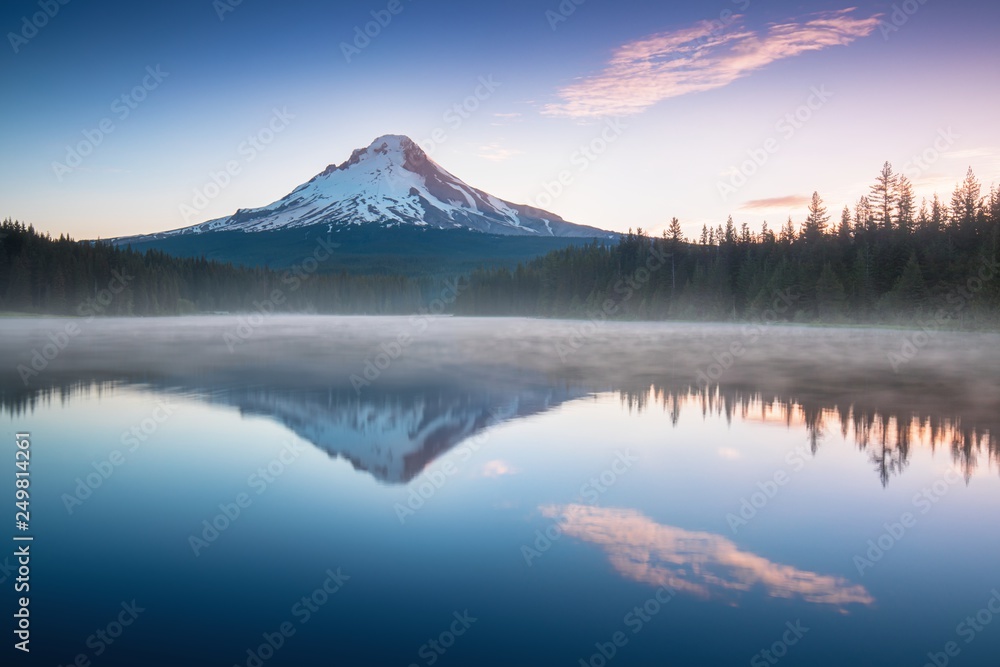 The volcano mountain Mt. Hood, in Oregon, USA. At sunset with reflection on the water of the Trillium lake. Beautiful landscape background concept.