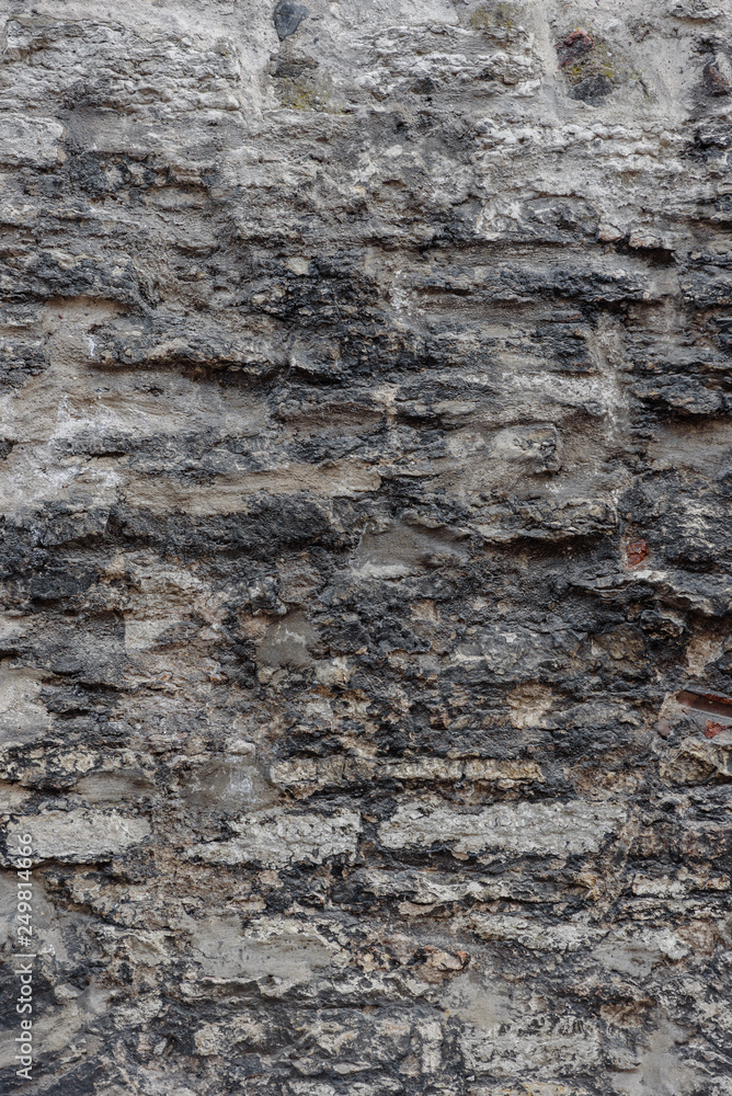 Fragment of old gray brick stone wall background