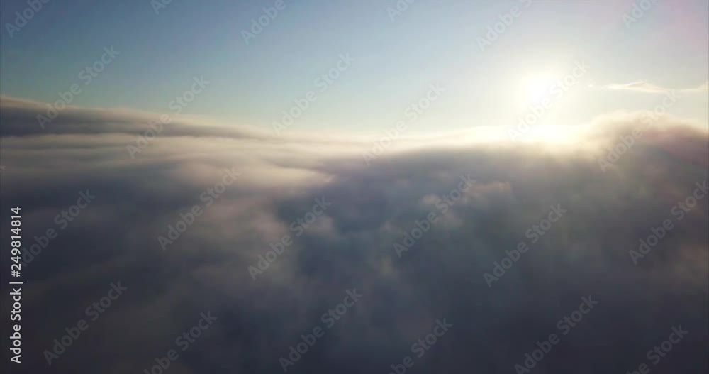 Flying backwards above the clouds. Breathtaking aerial view of the morning sun at sunrise. Sikhote-Alin Nature Reserve, a biosphere reserve in Russia for endangered Siberian tiger founded in 1935 Flying backwards above the clouds. Breathtaking aerial view of the morning sun at sunrise. Sikhote-Alin Nature Reserve, a biosphere reserve in Russia for endangered Siberian tiger founded in 1935