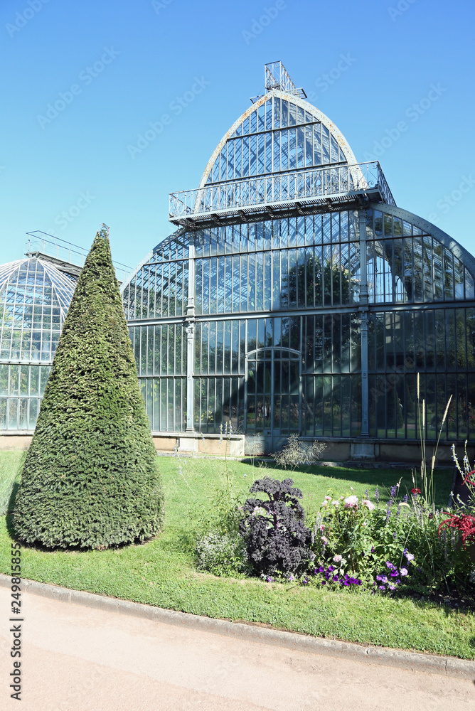 glass and steel greenhouse in the public park in Lyon with many
