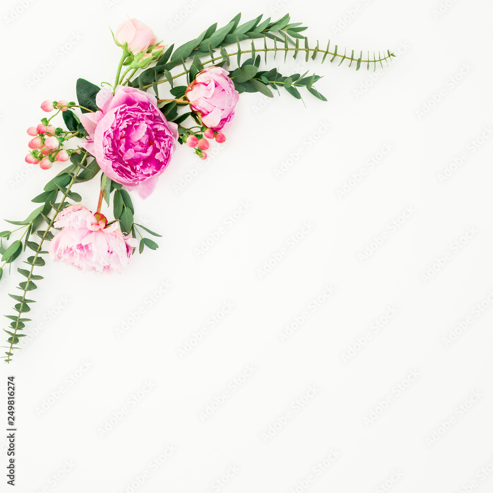Floral frame of pink peonies and roses flowers and eucalyptus on white background. Flat lay, top view