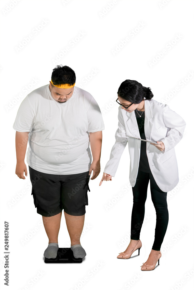 Female doctor examines her patient by using scales