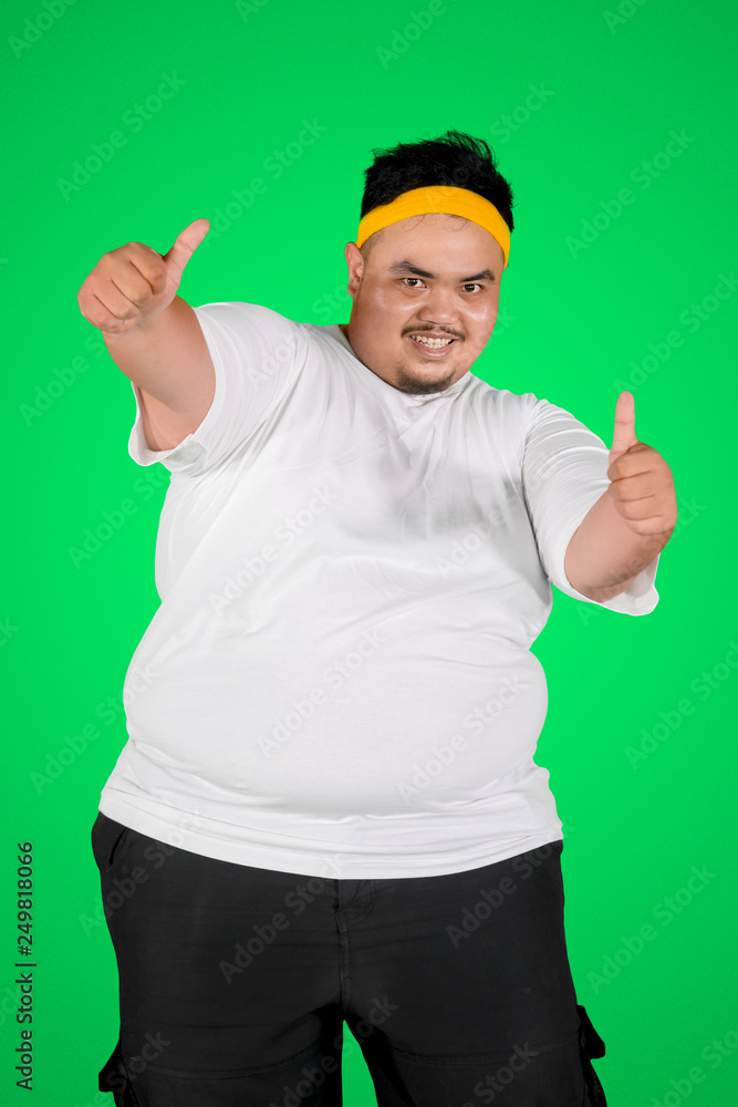 Happy fat man showing thumbs up on studio Happy fat man showing thumbs up on studio