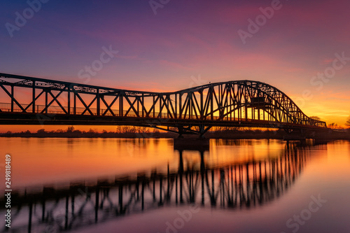 iron truss bridge at sunset