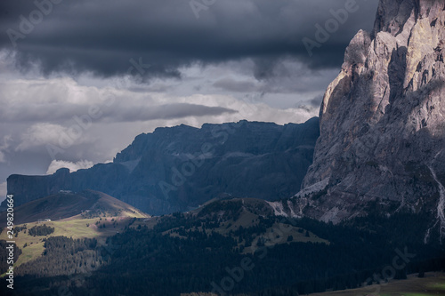 Massive mountains with clouds in the evening sun. A lot of stone structure and partly covered with clouds. Tele Objective. Langkofel Seiser Alm