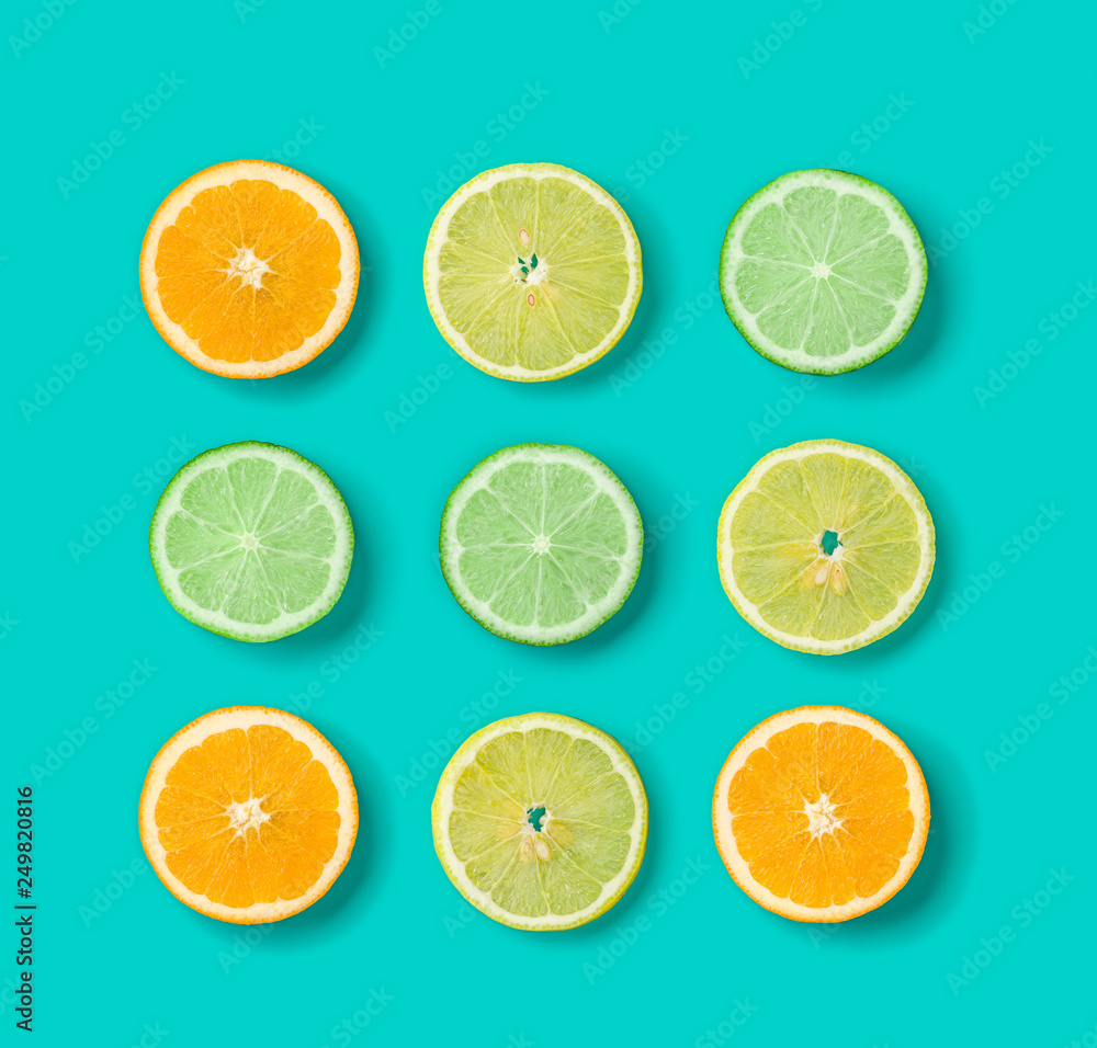 Citrus Fruit pattern on blue background. Orange, Lime, Lemon slices background. Flat lay, top view. . Pop art design, creative summer concept. Citrus Fruit pattern on blue background. Orange, Lime, Lemon slices background. Flat lay, top view. . Pop art design, creative summer concept.