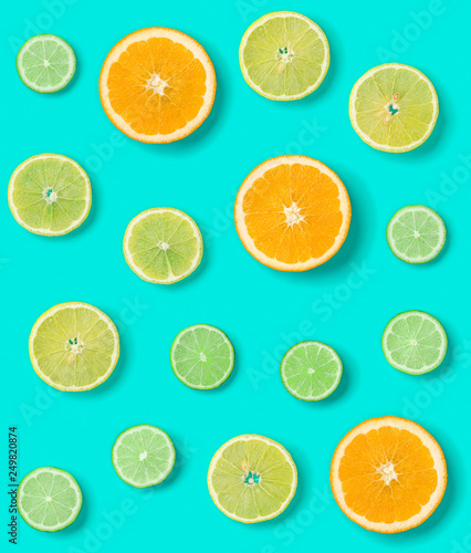 Creative layout made of colorful tropical fruits isolated on blue background. Minimal summer exotic concept. Citrus fruit seamless pattern.