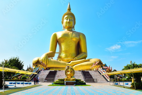 The large Buddha image is enshrined on a large pedestal with a sky backdrop.