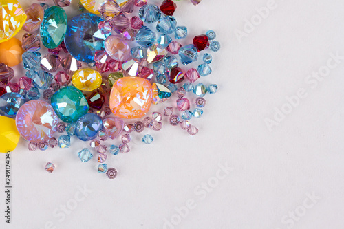 Gemstones crystals for jewelry scattered on white background