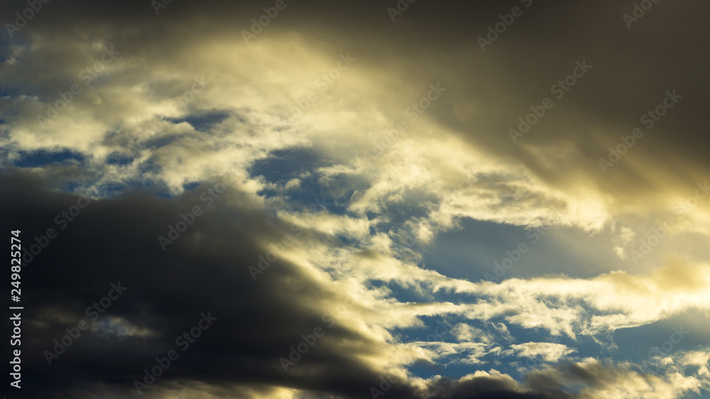 dark moody cloud scene with sun shining through