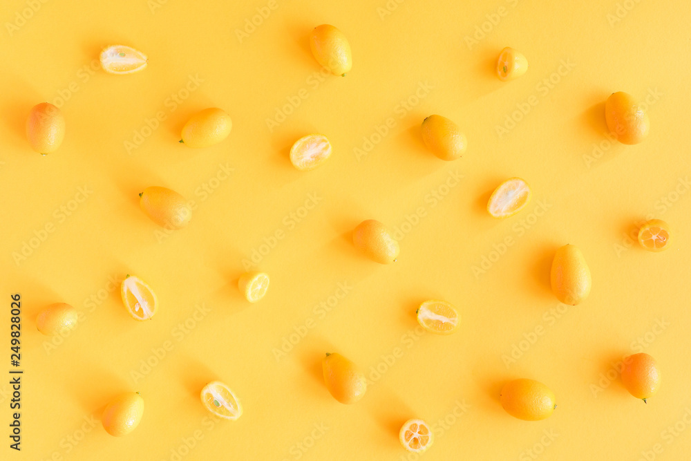 A slices of fresh juicy yellow Kumquats. Texture summer bright background, pastel pattern. A slices of fresh juicy yellow Kumquats. Texture summer bright background, pastel pattern.