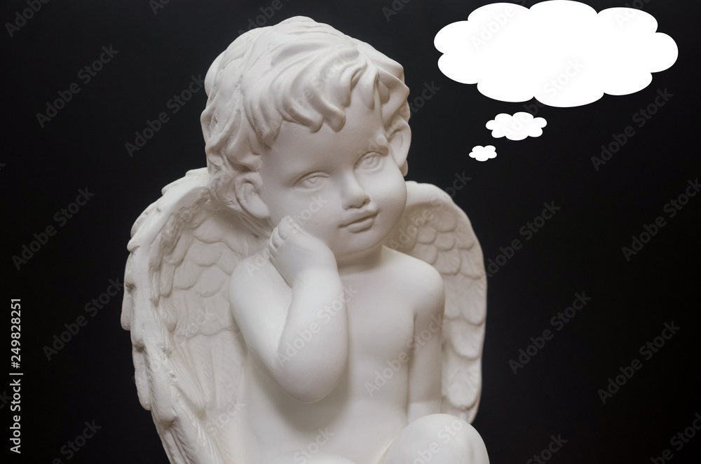 Beautiful white angel on black background close-up. Symbol of love, faith and hope. Place for text Beautiful white angel on black background close-up. Symbol of love, faith and hope. Place for text