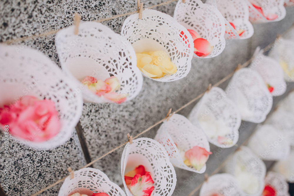 paper baskets with rose petals hung in the wedding ceremony area paper baskets with rose petals hung in the wedding ceremony area