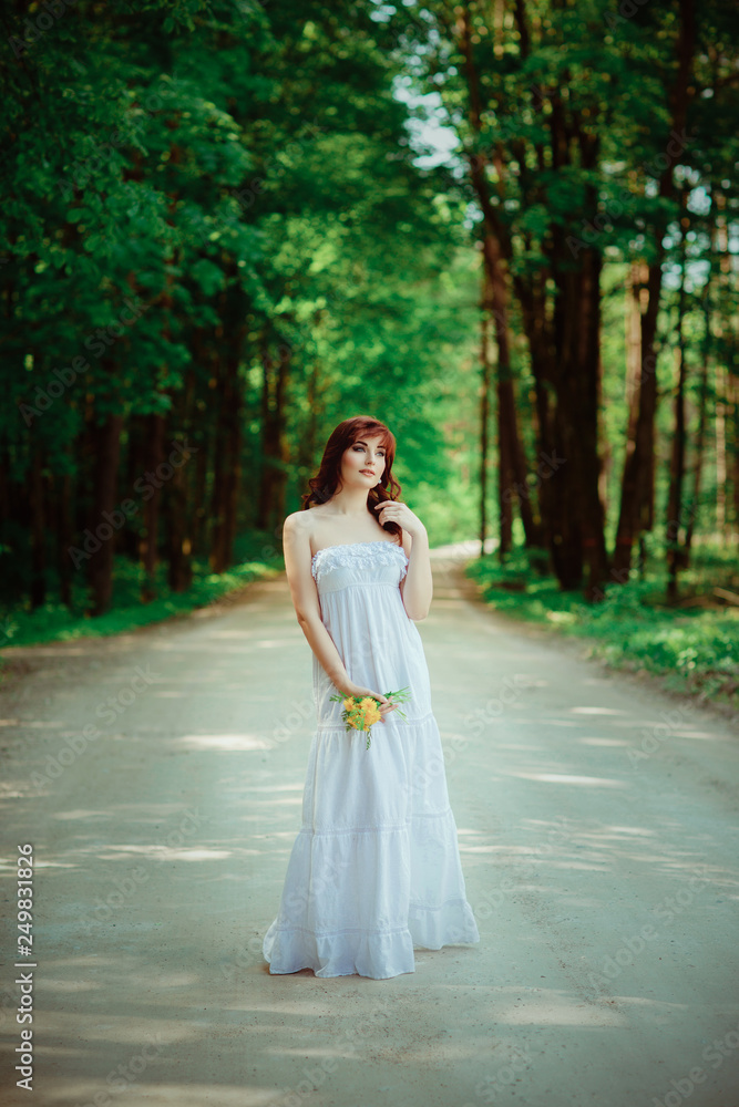 beautiful girl with dandelion flowers on forest road beautiful girl with dandelion flowers on forest road