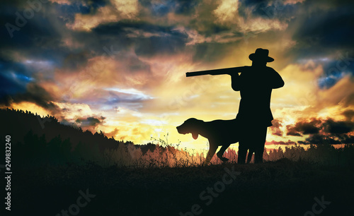 hunter with dog at sunset.