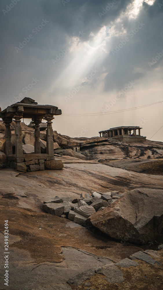 little stone temple with dramatic mystic sky in hampi india karnakata