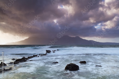 Beautiful, dreamy sky and the sea in Scotland Waves crossing on shoreline with moody dramatic sky on the Isle of Skye, Scotland, UK The place is in Isles in north atlantic ocean travel