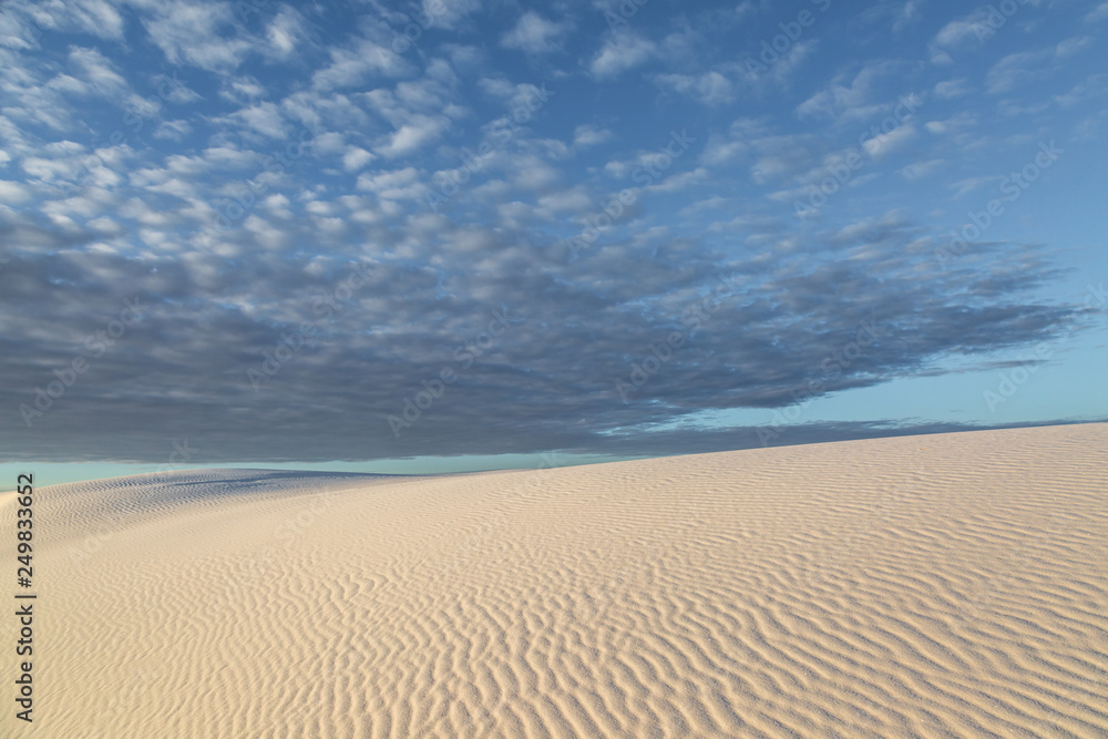 Clouds over the sand dunes at sunrise, at White Sands National Monument, New Mexico