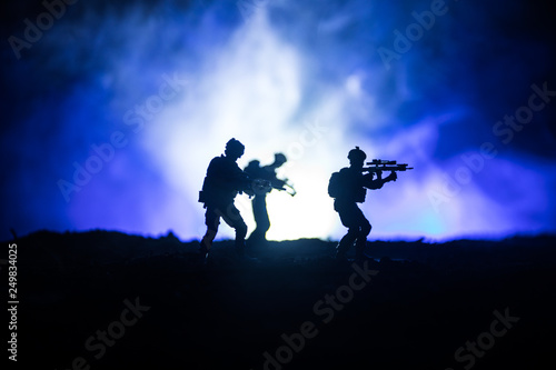 Military soldier silhouette with gun. War Concept. Military silhouettes fighting scene on war fog sky background, World War Soldier Silhouette Below Cloudy Skyline At night.