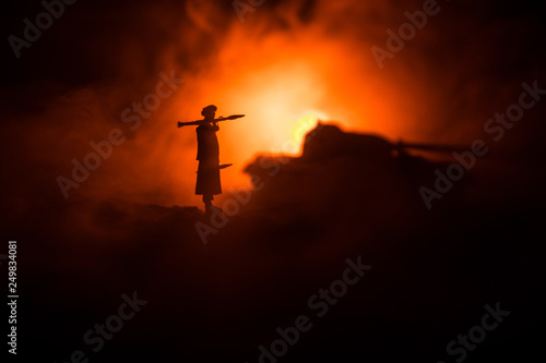 Military soldier silhouette with bazooka. War Concept. Military silhouettes fighting scene on war fog sky background, Soldier Silhouette aiming to the target at night photo