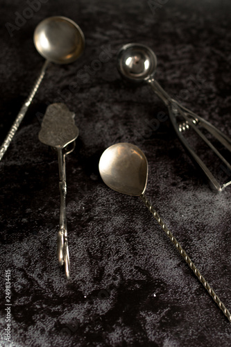 Old cutlery. On a black stone background. Top view.