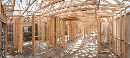 Panoramic interior view of a  wooden timber frame from a new house under construction photo