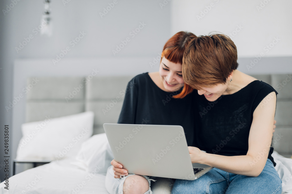 cheerful girls watching funny film, movie, video from the laptop. close up photo. happiness, feeloing, emotion concept, hobby cheerful girls watching funny film, movie, video from the laptop. close up photo. happiness, feeloing, emotion concept, hobby