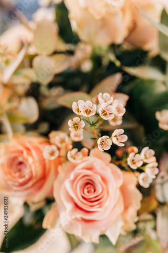 Pink Roses bouquet in a vase on a wooden table. Florist