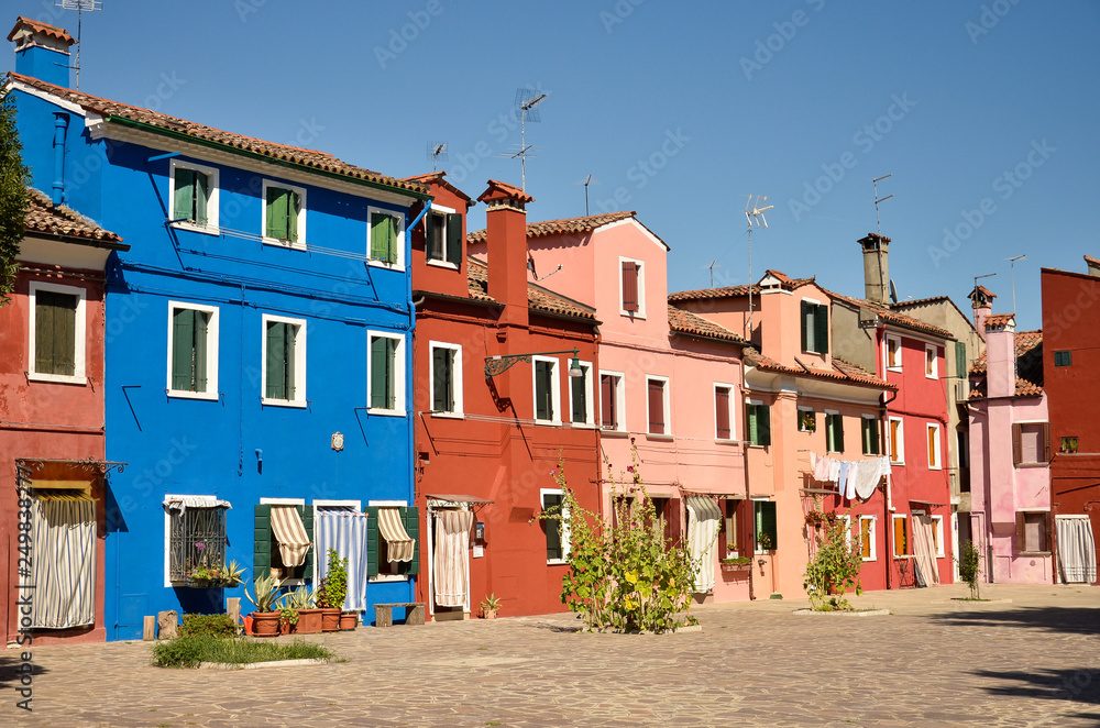 Venice, Burano, small colored houses. Colorful concept, orange and blue