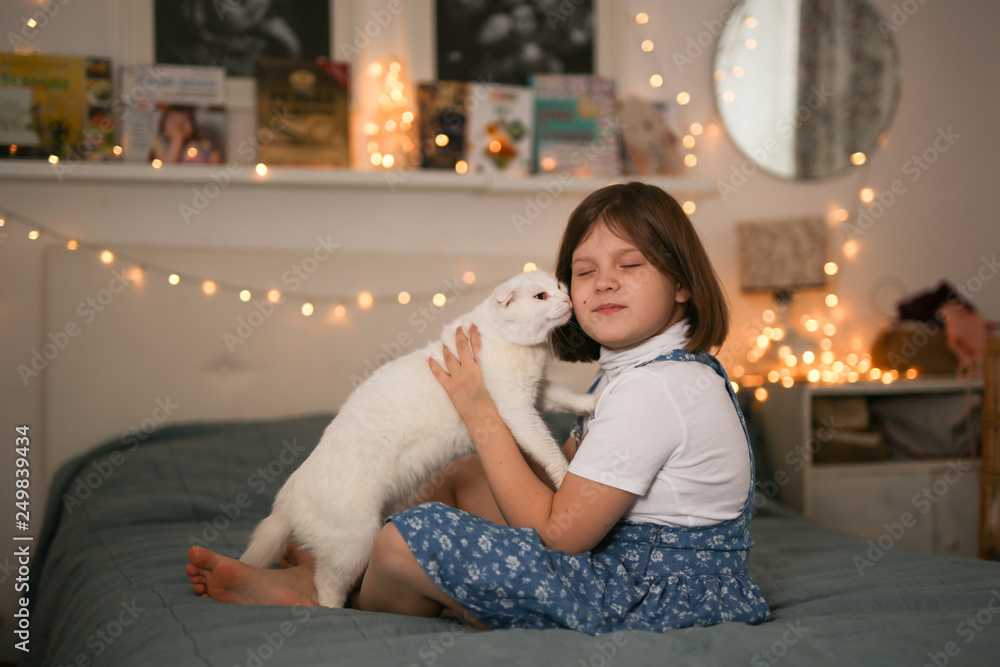 child playing with cat on bed in bedroom,lifestyle child playing with cat on bed in bedroom,lifestyle