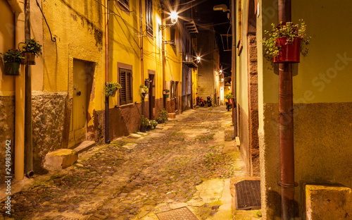 Fototapeta Naklejka Na Ścianę i Meble -  Narrow ancient streets during the evening in the little medieval town Bosa, Sardinia Island, Italy