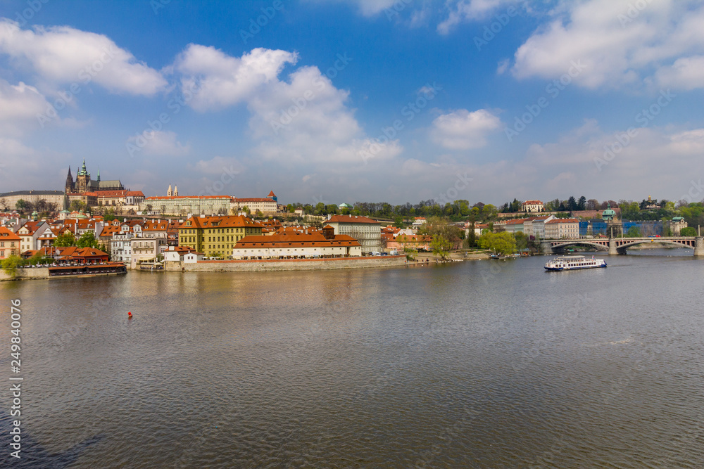 View of historical center of Prague, buildings and landmarks of old town. Boat cruise on Vltava river. Czech Republic. Top tourist attraction in Europe. Concept of travel, sightseeing and tourism. 