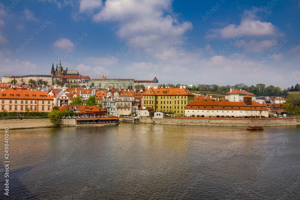 View of historical center of Prague, buildings and landmarks of old town. Boat cruise on Vltava river. Czech Republic. Top tourist attraction in Europe. Concept of travel, sightseeing and tourism. 